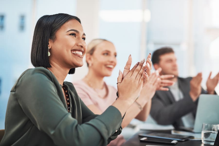 two women smiling clapping while sitting