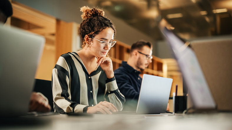 women smiling at computer